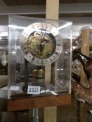 A W & H 8 day clock movement on 2 gongs on modified stand and in perspex display case,