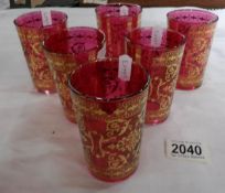 A set of 6 Italian cranberry glass tumblers overlaid with gold decoration.