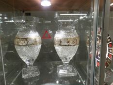 A pair of gold decorated cut glass vases.