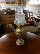 A metal based oil lamp with etched shade.