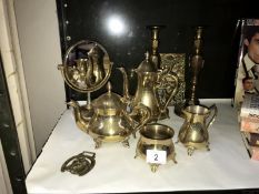 A brass 4 piece tea set candlesticks etc.