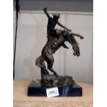 A bronze figure of a cowboy riding a rearing horse, signed (possibly Kauba).