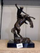 A bronze figure of a cowboy riding a rearing horse, signed (possibly Kauba).