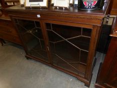A Victorian mahogany astragal glazed cabinet with mirror back.