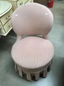 A candy striped covered bedroom chair