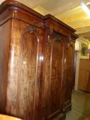 A large Victorian mahogany break front wardrobe.