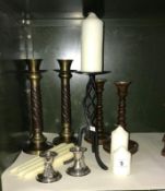 3 pairs of candlesticks and 1 other and a quantity of candles