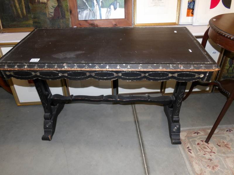 A 19th century ebonised side table heavily inlaid with mother of pearl and leather.