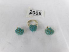 An 18ct gold and turquoise ring, size P, together with a pair of matching earrings.