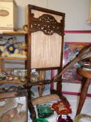 A Victorian mahogany fire screen.