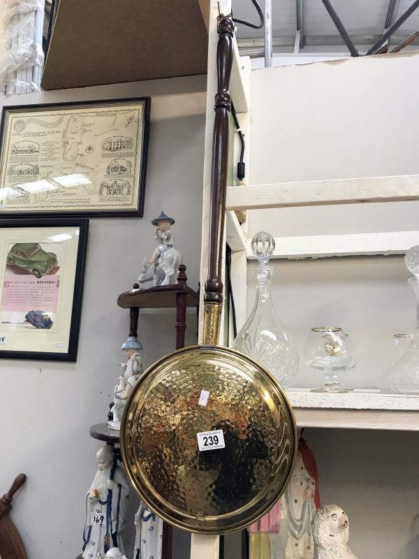 An ornamental brass warming pan
