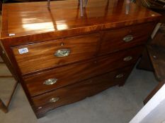 A 2 over 2 mahogany chest of drawers with brass handles.