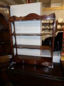 A medium oak book shelf/plate rack with 3 drawers.