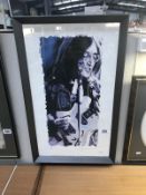 A limited edition 48/850 framed and glazed print of John Lennon by Leon Evans signed by artist