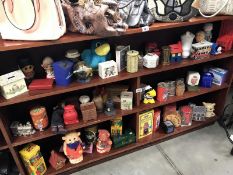 A large collection of novelty money boxes and other money boxes