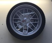 A wall clock in the form of an alloy car wheel