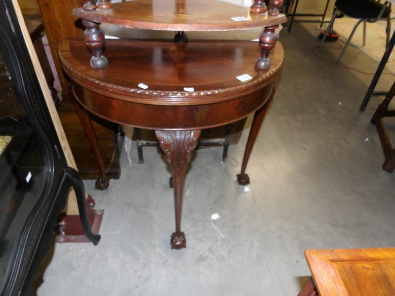 A Victorian mahogany fold over D end card table with ball and claw feet and pull out leg.