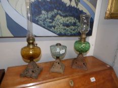3 oil lamps with coloured glass fonts.