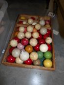 A large quantity of old snooker balls including some ivory,