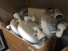 A large box of white 3 arm ceiling spot lights