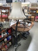 A wrought iron floor standing standard lamp