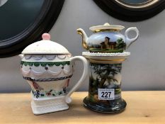 A hand painted small teapot on stand and one other designed to look on plinth