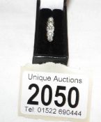 A platinum set 5 stone diamond ring circa 1940's in 18ct gold tested, size M.