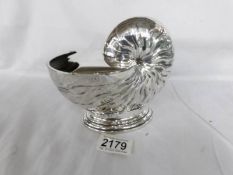 A silver plated Nautilus shell shaped spoon warmer.