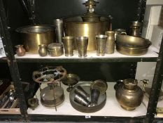 2 shelves of brassware including oil lamps, pans, primus stove etc.