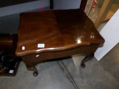 A mahogany work table on Queen Anne style legs.