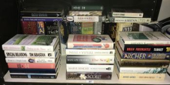 35 assorted signed novels including Jeffrey Archer, Brian Freemantle, Ben Okri, John Le Carre,