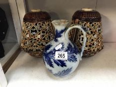 A Royal Doulton jug by George Tinworth (poorly repaired damage to spout) and a pair of ceramic lamp