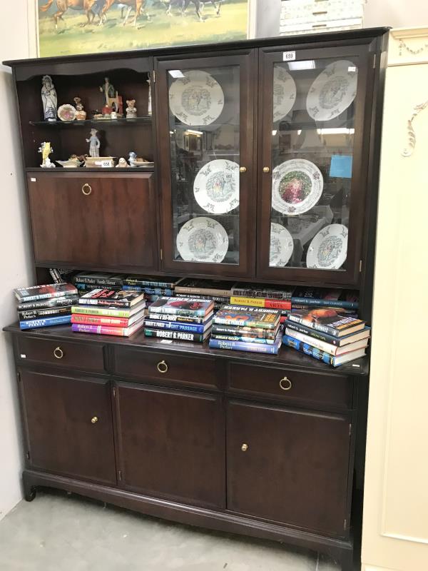 A dark wood stained sideboard/wall unit with bevelled glass