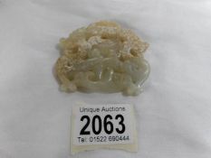 A late 19th century piece of carved jade (stained).