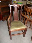 A late 19th / early 20th century oak carver chair with rosette carvings.