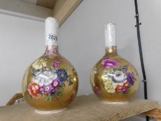 A pair of gold and floral decorated Dresden vases.