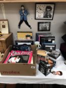 A box of Elvis Presley collectables including boos, mugs, clocks, records etc.