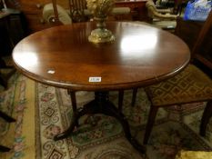 An oak tripod dining table.