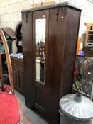 A 1930's oak wardrobe with bevelled mirror door