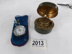 An 800 silver ladies pocket watch and a travelling inkwell.