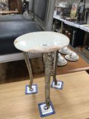 A marble topped 3 legged table
