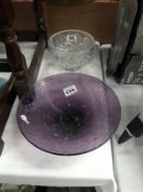 A purple glass bowl and a lead crystal bowl