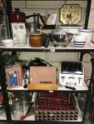 3 shelves of kitchenalia including storage jars, cutlery etc.