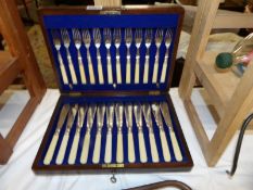 A 1930's oak cased canteen of fish knives and forks.