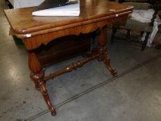 A Victorian mahogany fold over card table (Worm in legs).