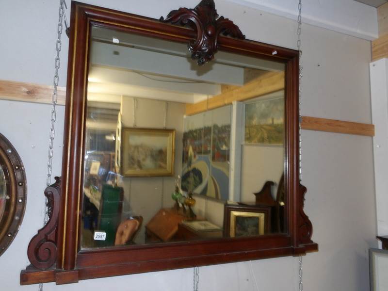 A large mahogany over mantel mirror.