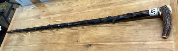 A vintage walking stick with antler handle and knobbly shaft