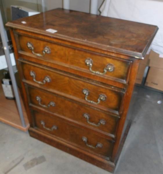 A 20th century walnut veneer 4 drawer chest.