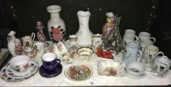 A shelf of mixed pottery and porcelain including cups, saucers, vases etc.
