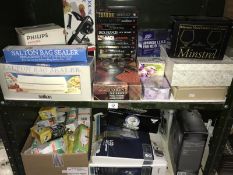 A quantity of mostly new boxed items including infrared lamp, tens machine, electric razor, glasses,